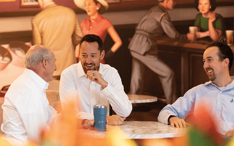 Sashco founder, Les Burch enjoying a coffee and conversation with his sons discussing the future of the company with BOK Financial.